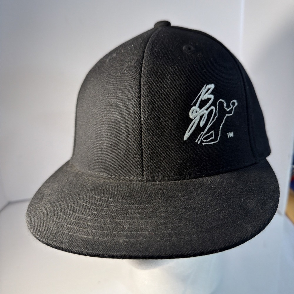 Black snapback cap with a white embroidered stylized figure logo.